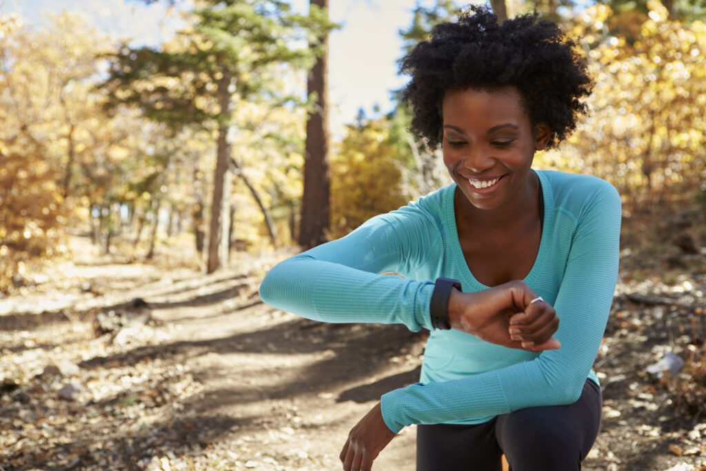 young woman checking fitness monitor